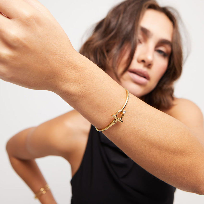 Uno de 50 Gold Plated Bangle bracelet with white topaz